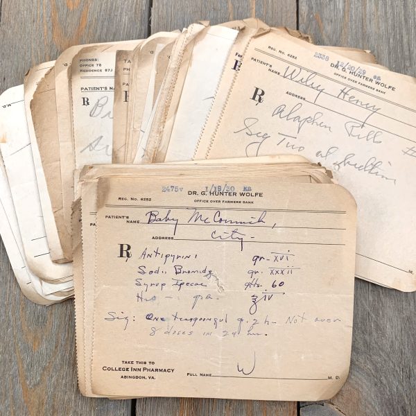 A spread out pile of vintage handwritten medical prescriptions from the 1920s and 1930s.