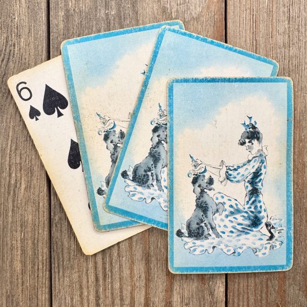 4 Vintage blue and white playing cards featuring a birthday girl placing a party hat on a dog.