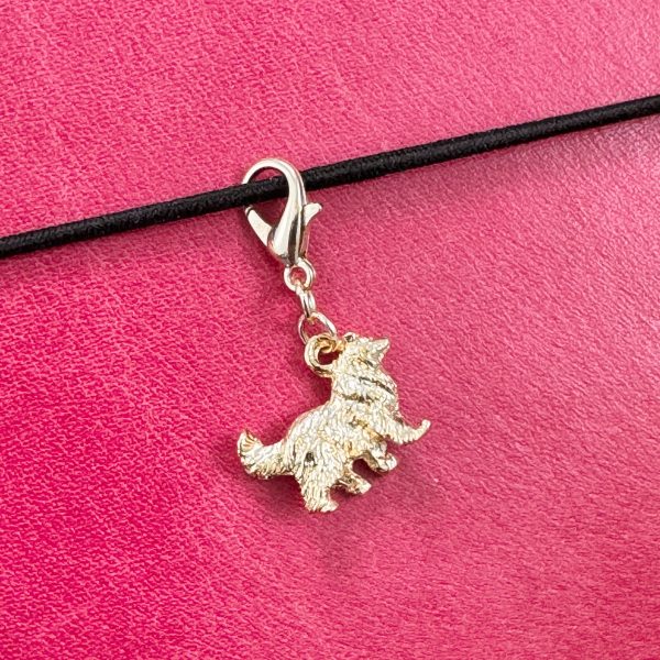 1 Handmade vintage gold-tone Collie charm with lobster clasp on a pink leather journal.