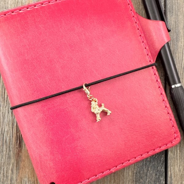 1 Handmade vintage gold-tone poodle charm with lobster clasp on a pink leather journal.