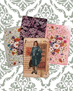 A collaged altered vintage playing card, laid out on three different vintage floral playing cards