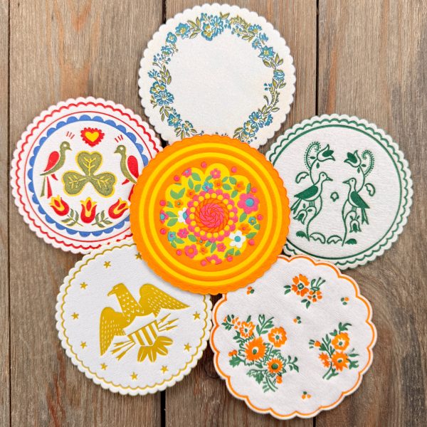 Six different vintage paper coasters with vibrant designs
