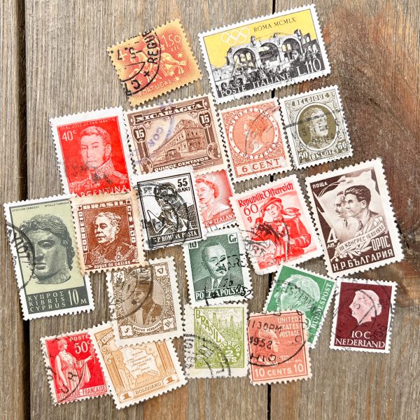 20 different vintage and antique postage stamps in various colors - orange, yellow, green, and brown