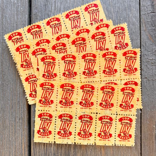 A pile of 5 yellow and red Top Value saving stamp sheets, each containing 10 stamps
