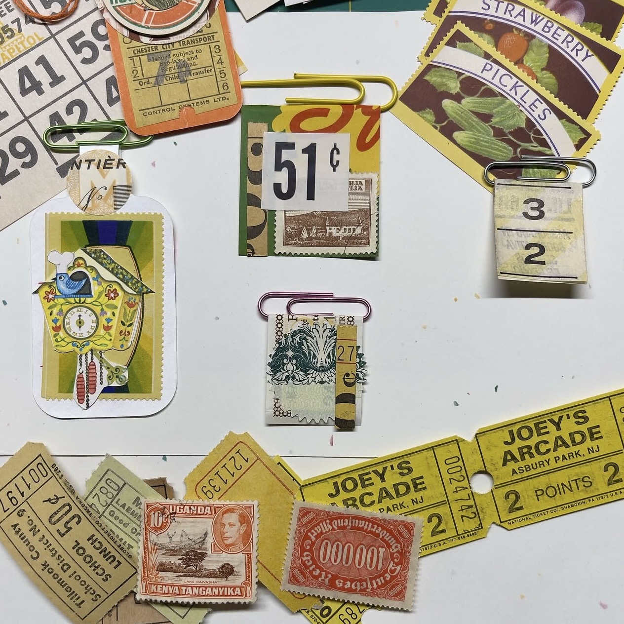 Altered paper clips, collaged with vintage ephemera