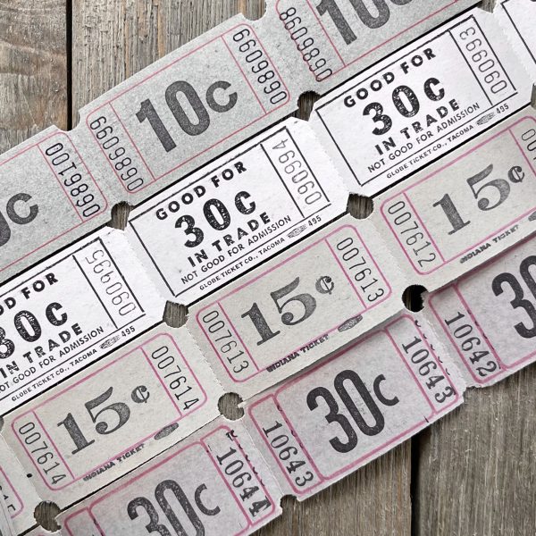 Four rows of vintage grey and white carnival tickets