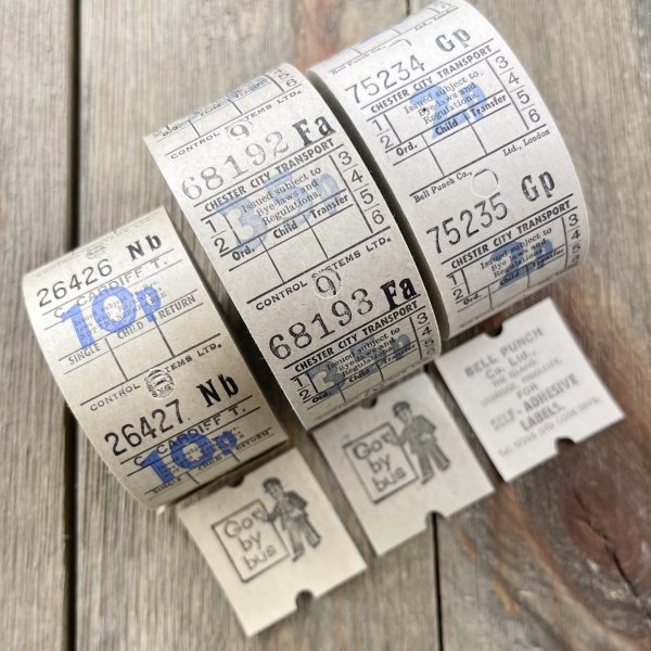 Three rolls of vintage white British bus tickets
