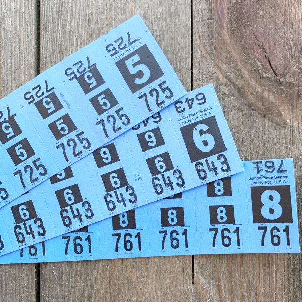 Three strips of vintage sky blue dry cleaning tickets