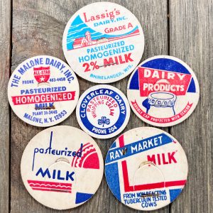 Six different vintage mid-century red, white, and blue milk caps