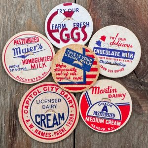 Six different vintage mid-century red, white, and blue milk caps