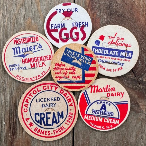 Six different vintage mid-century red, white, and blue milk caps