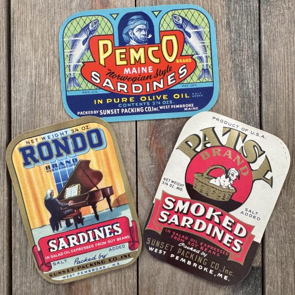Three different vintage illustrated sardine can labels from the 1940s