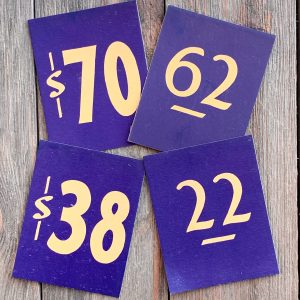 Four different vintage navy blue price cards with yellow text