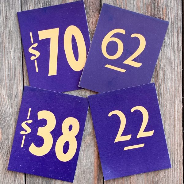 Four different vintage navy blue price cards with yellow text
