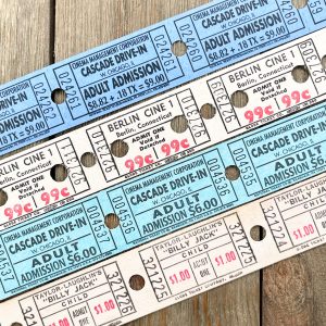 Four rows of vintage movie theatre tickets in shades of blue, aqua, and white