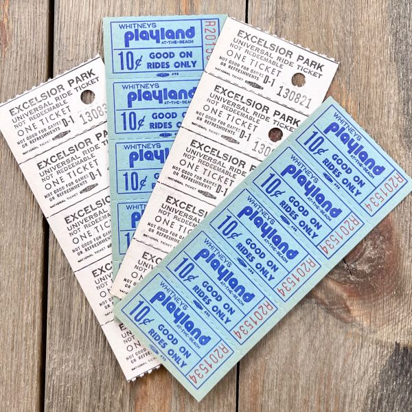 Four strips of blue and white amusement park ride tickets