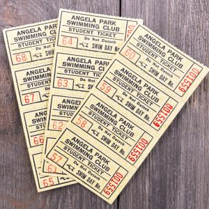 Three strips of four yellow Angela Park Swimming Club coupon book tickets