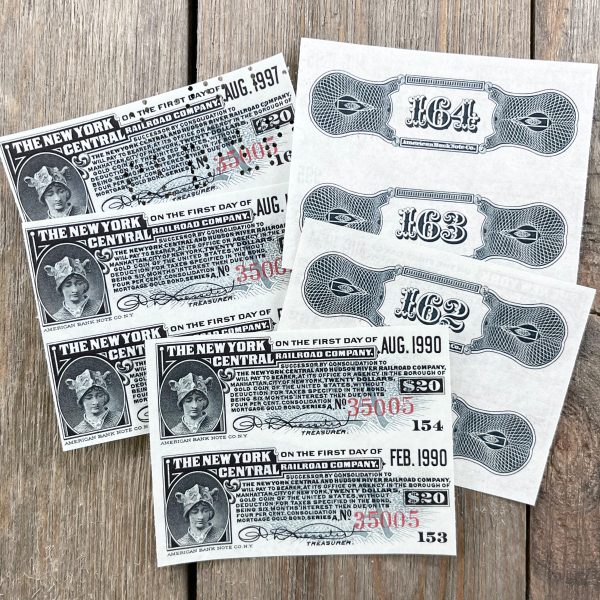 Ten antique grey railroad bond coupons