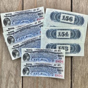 Ten antique blue railroad bond coupons