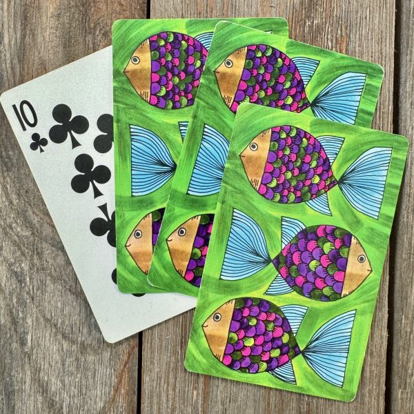 Four vintage playing cards featuring colorful cartoon fish
