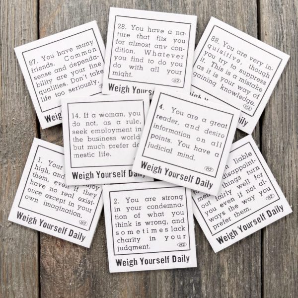 Eight random small vintage black and white penny scale fortunes that say Weigh Yourself Daily at the bottom of each