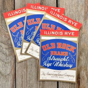 Four vintage red, white and blue Old Rock Brand Whiskey Labels with gold accents