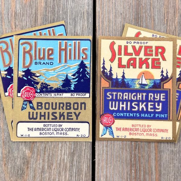 Four assorted vintage whiskey labels with gold accents